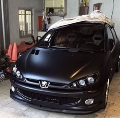 a black car is parked in a garage