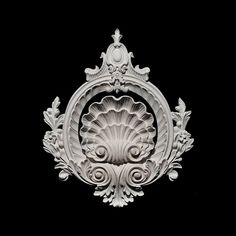 an intricately carved wall decoration on a black background