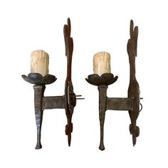 two candle holders made out of metal and wood