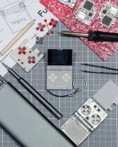 some tools are laying out on top of a table with paper, scissors and other items