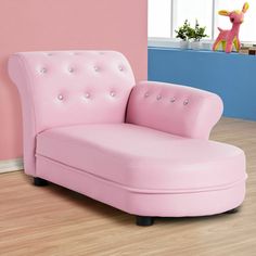 a pink chair sitting on top of a hard wood floor