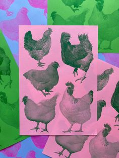 four different colored hens on pink, green and purple paper with black ink in them