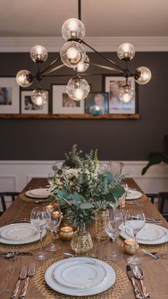 a dining room table with plates and silverware