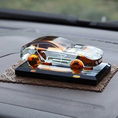 a toy car is sitting on top of a cloth in the back seat of a car