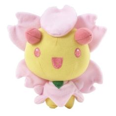 a yellow stuffed animal with pink ears and wings