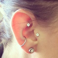 a woman with three piercings on her ear