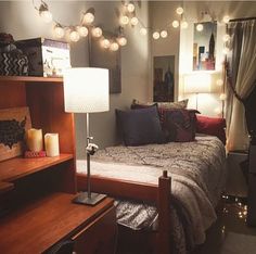 a bed room with a neatly made bed and lots of lights