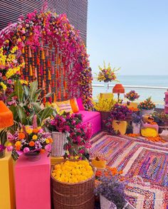 an outdoor area with flowers and baskets on the ground, along with other items for decoration