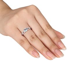 a woman's hand with a diamond ring on it