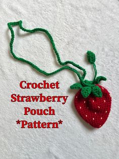 the crochet strawberry pouch pattern is shown on a white towel with green string