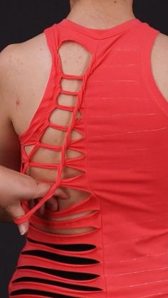 the back of a woman's red top with cutouts
