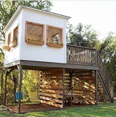 a tree house with stairs leading up to the upper floor and second story above it