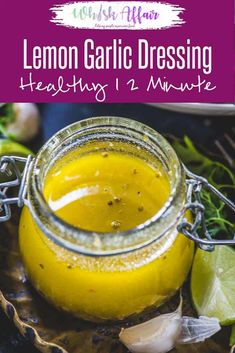 a jar filled with lemon garlic dressing sitting on top of a table