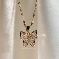 DESCRIPTION: Part of our exclusive "The Butterfly Collection", this gorgeous high polish 18K Gold Plated Butterfly Kiss necklace is so gorgeous and cute! Embedded with the highest quality of baguette cut Cubic Zirconia crystals, this butterfly necklace shines like crazy in any kind of lighting! MATERIAL: 18K Gold Plated over Stainless Steel. Hypoallergenic, Tarnish Free and Water Resistant. LENGTH: Multiple chain sizes available for selection above. Pendant: 0.5 inch. Matching Butterfly Anklet i Kiss Necklace, Dope Jewelry Accessories, Butterfly Anklet, Designer Hair Accessories, Butterfly Necklace Gold, Pretty Jewelry Necklaces, Butterfly Collection, Jewelry Accessories Ideas, Dope Jewelry