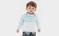 a little boy standing in front of a white background wearing a sweater and jeans with blue stripes