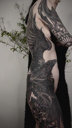 a woman with black tattoos on her body