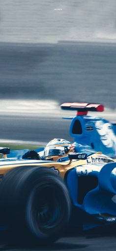 a blue and yellow race car driving on a track