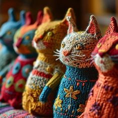 colorful knitted cats are lined up in rows