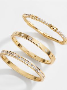 For fans of bands, there's the Maddie 18K Gold Ring Set. Featuring one thicker and two smaller bands, this set can be broken apart on multiple digits or worn all on one. The two smaller bands feature gorgeous Cubic Zirconia detailing, while the larger is plain gold. Crafted with 18K gold plated sterling silver, this is sure to be one of your new favorite pieces of jewelry. Gold Medallion Necklace, Safety Pin Earrings, Gold Ring Set, Engagement Rings Affordable, 18k Gold Earrings, Jewels Rings, Opal Ring Gold, Gold Ring Sets, 18k Gold Ring