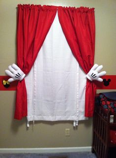 a red and white curtain with mickey mouse ears on it