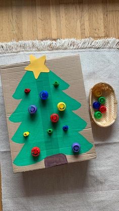 a christmas tree made out of cardboard with buttons