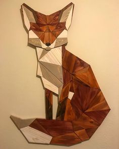 a wooden cut out of a fox sitting on top of a wall