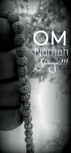 a hand holding a rosary with the words om namah saraam
