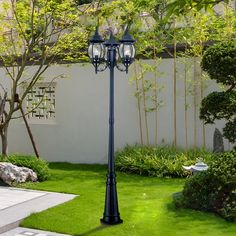 a lamp post in the middle of a garden