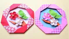 two origami flowers are on top of each other in different colors and shapes