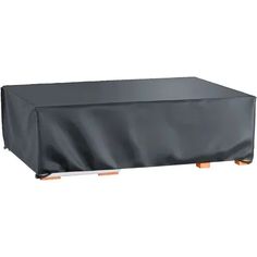 an outdoor table covered with a black cover