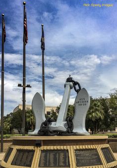 there is a statue in front of flags