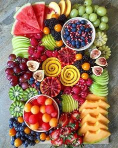 a variety of fruits are arranged on a cutting board