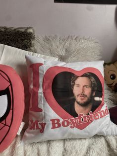 i love my boyfriend pillow on top of a bed next to a teddy bear and stuffed animal