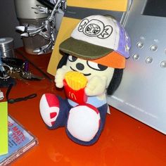 a stuffed toy sitting on top of a desk