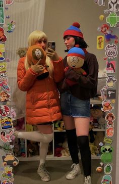 two women standing in front of a mirror with stickers on it