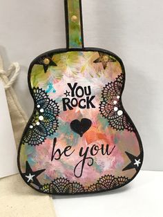 a guitar case with the words you rock be you painted on it