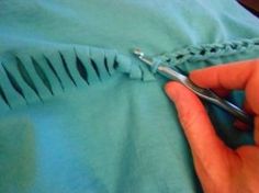 someone is cutting the end of a piece of fabric with scissors