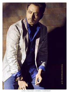 a man sitting on top of a chair next to a brick wall