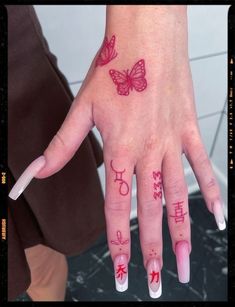 a woman's hand with two butterflies on it and the word love written in chinese