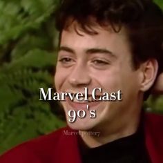 a man smiling and wearing a red jacket with the words marvel cast 90's in front of him