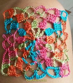 a close up of a person's arm with crocheted bracelets on it