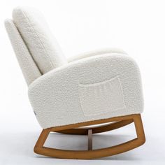 a white rocking chair with a wooden frame and cushion on the back, in front of a white background