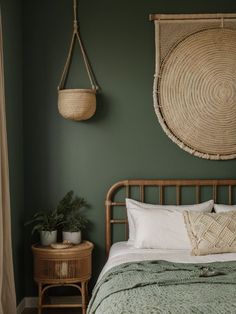 a bedroom with green walls and wicker bed frame, rattan basket hanging on the wall