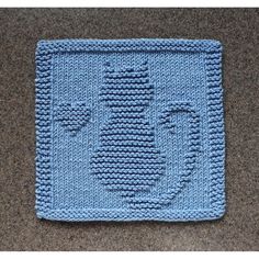 a crocheted blue square with the word love on it