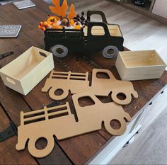 cardboard cutout vehicles sitting on top of a wooden table