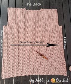 the back side of a pink knitted blanket with an arrow pointing to it and labeled directions