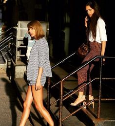 two women walking down the street at night