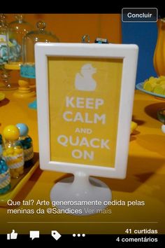 a sign that says keep calm and quack on in front of a yellow table