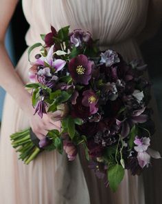 a bride holding a bouquet of flowers in her hands