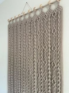 a crocheted curtain hanging on the wall